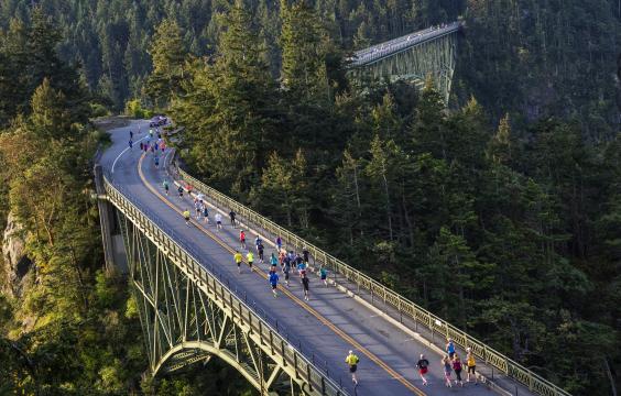 Deception Pass Bridge with marathon runners, running across bridge.