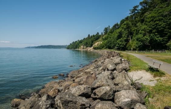A view of a paved trail along the water at Saltwater State Park
