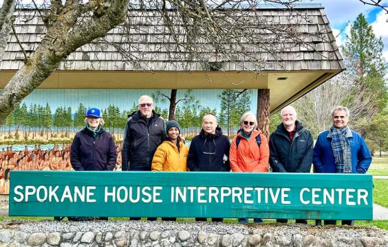 The seven members of the Washington State Parks Recreation stand in front of the Spokane House Interpretive Center at Riverside State Park.  They are wearing winter clothing.