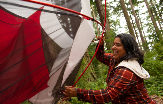 person trying to set up tent at a campsite