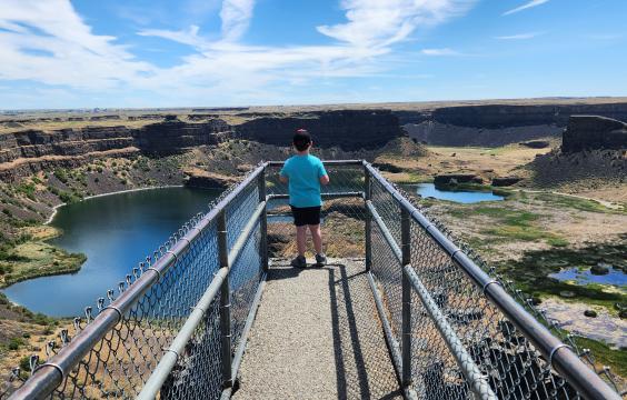 Boy standing on pier lookout at the Dry Falls Visitor Center